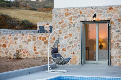 a chair sitting on the side of a building at Desiterra Resort & Spa in Fira
