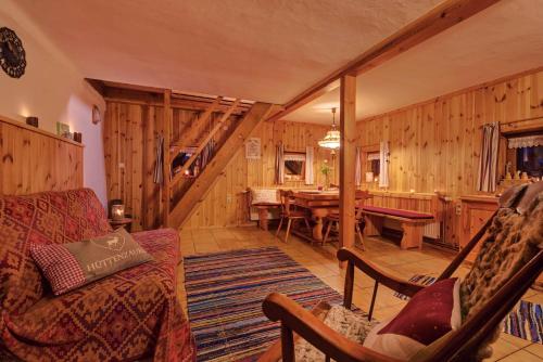 a living room with wooden walls and a table and chairs at Wachahof in Edlitz