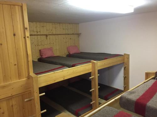 a room with two bunk beds in it at Restaurant Fleschboden in Rosswald