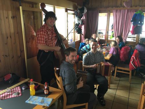 a group of people sitting at a table in a room at Restaurant Fleschboden in Rosswald