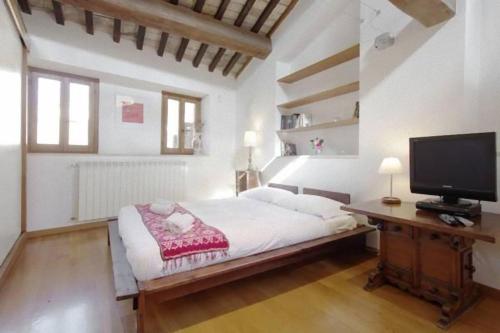 een slaapkamer met een bed en een tv op een bureau bij Casa Paradiso in Rome