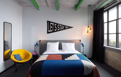 a bedroom with a bed and a sign on the wall at The Social Hub Maastricht in Maastricht