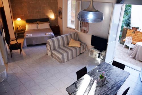 a living room with a couch and a bed at ArtRoom Garden in Noto