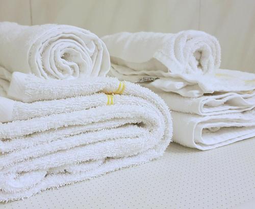 una pila de toallas blancas sentadas en una mesa en Blåtind Apartments en Stordal