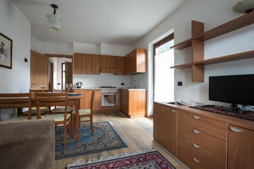 a kitchen with a table and a dining room at Chalet Santa Barbara in Bormio