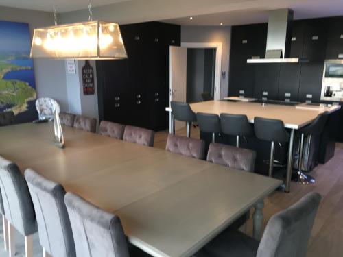 a conference room with a long table and chairs at Ocean View,Kinsale, Hosted by Exquisite holiday homes, sleeps 22 in Kinsale