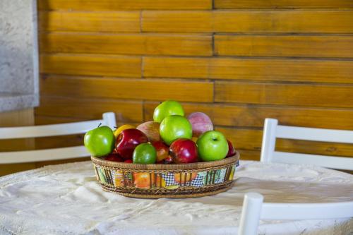 a basket of fruit sitting on a table at Ricky Chalet Near Troodos in Spilia