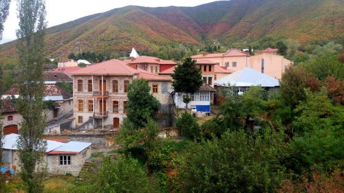 a group of buildings in front of a mountain at Sheki Palace Hotel in Sheki