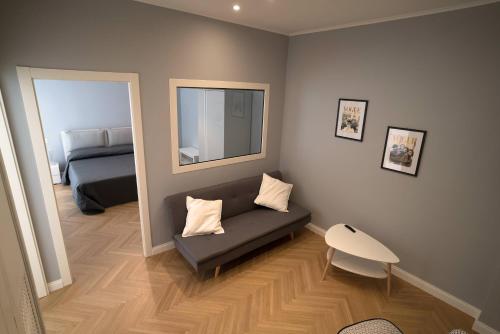 a living room with a couch and a bed at Room 56 in Bari