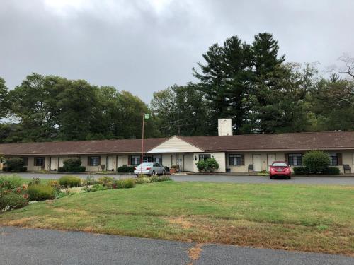a building with cars parked in a parking lot at The Walpole Motel in Walpole