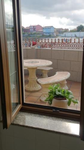 a view of a patio from a window at Casa Riveira Grande,Il Apartamentos in Boiro