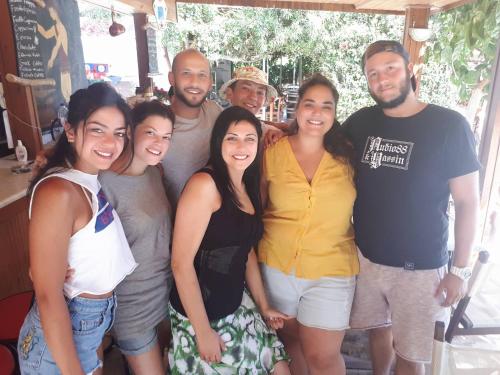 a group of people posing for a picture at XeniCamp & Bungalows in Tolo