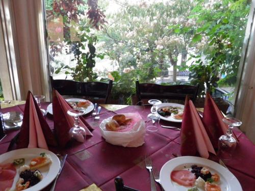 a table with plates of food on a purple table cloth at Hotel Derby in Bellaria-Igea Marina