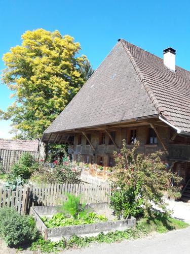 a wooden house with a fence in front of it at Bühl 3 in Affoltern