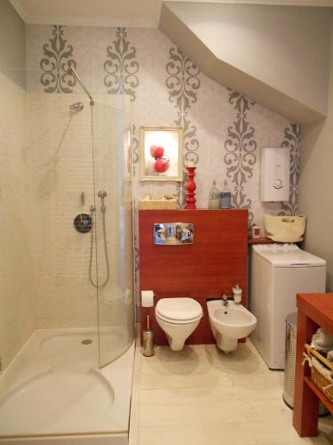 a bathroom with a shower and a toilet and a sink at Vintage Luxurious house in Sombor