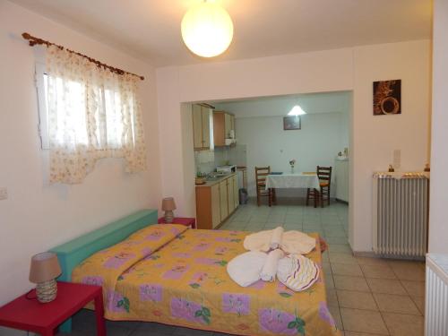 a bedroom with a bed and a kitchen and a table at Small studio near the center of Tripoli in Tripoli