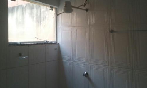 a bathroom with a shower and a window at Shalon Hotel in Uberaba
