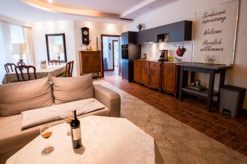 a living room with a couch and a table at Apartament Perła Kartuz z sauną in Kartuzy