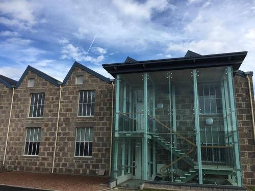 a brick building with a glass revolving door at The Sidings Inverurie in Inverurie