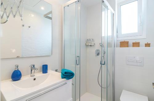 a bathroom with a sink and a shower at Azteka Blue 2 Bed Apartment Calella de Palafrugell in Calella de Palafrugell