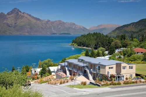 an aerial view of a house next to a lake at Alexis Motel & Apartments in Queenstown