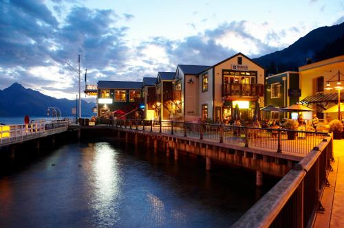 a group of buildings on a pier next to a body of water at Alexis Motel & Apartments in Queenstown