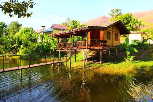a house on a bridge over a body of water at Baan Krupong in Ban Tha Thong Mon