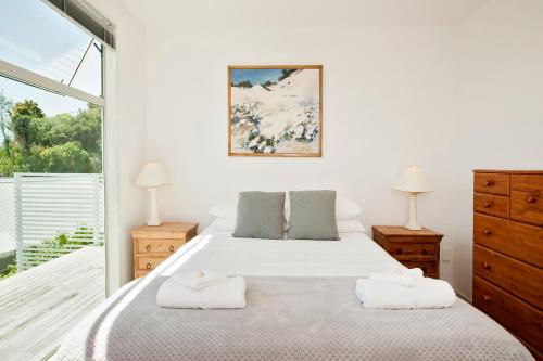 a bedroom with a large bed with towels on it at Robins Nest in Russell