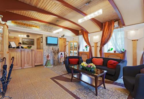 un soggiorno con divano e tavolo di Hotel Semigorie a Shaldovo