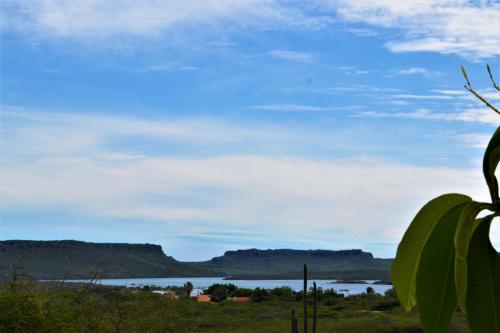 a view of a lake with mountains in the background at Jan Kok Lodges in Willibrordus