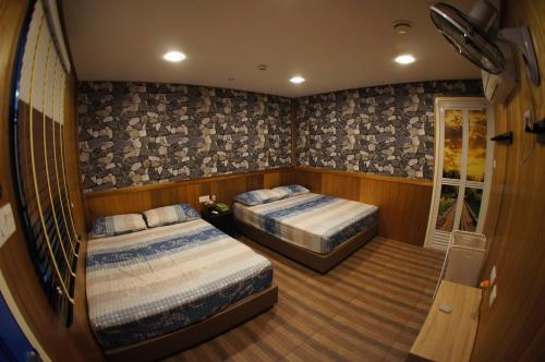 a bedroom with two beds in a boat at X Rector Minsu in Tioman Island