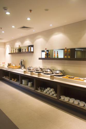 a kitchen with a lot of food on display at Shervani Nehru Place in New Delhi