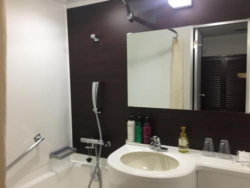 a bathroom with a sink and a mirror at Hotel 21 in Kusatsu