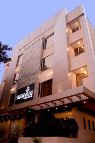 a building with a sign on the side of it at Shervani Nehru Place in New Delhi