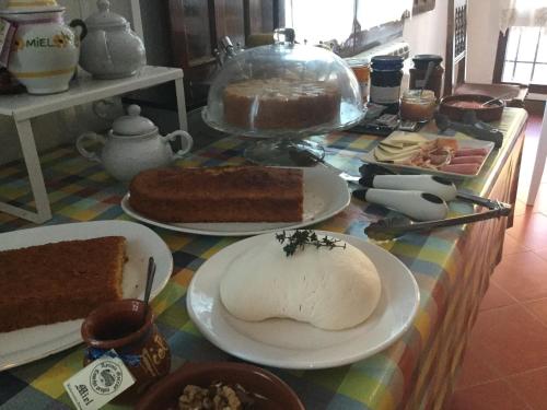 a table with different types of cakes and desserts at Casa Lola in Pelegrina