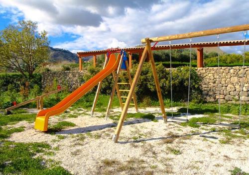 a playground with an orange slide in a park at Vecchia Dimora Resort in Centuripe
