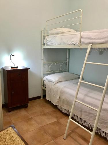 a bedroom with two bunk beds and a night stand at Casa Vacanze Il Cenito in Castellabate