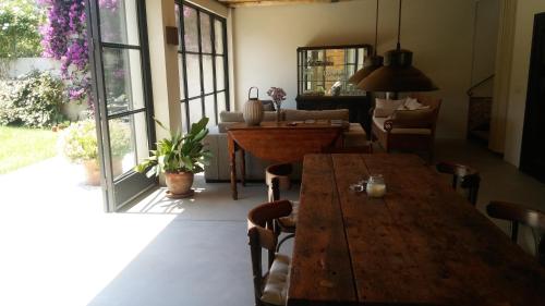 a dining room with a wooden table and chairs at Mas Ferran Adults Only in Pals