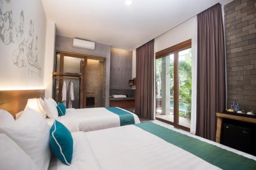 two beds in a hotel room with a balcony at Sarina Boutique Hotel in Phnom Penh