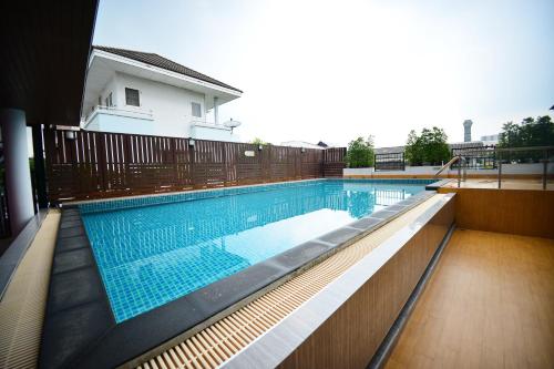a swimming pool with blue water in a house at Praso@Ratchada12 in Bangkok