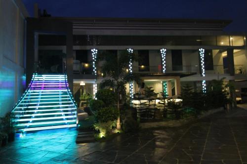 a building with a lit up walkway at night at Eloisa Royal Suites in Mactan