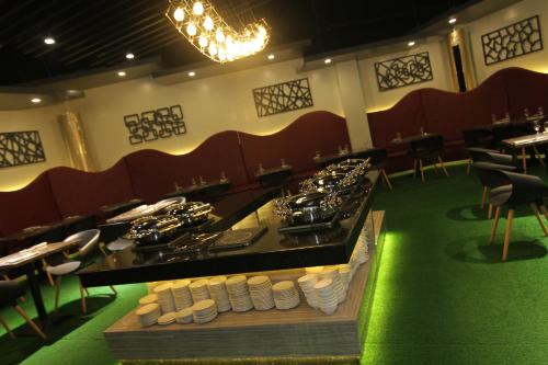 a dining room with a table with plates of food at Eloisa Royal Suites in Mactan