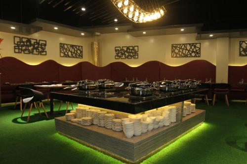 a restaurant with a counter with pots and pans at Eloisa Royal Suites in Mactan