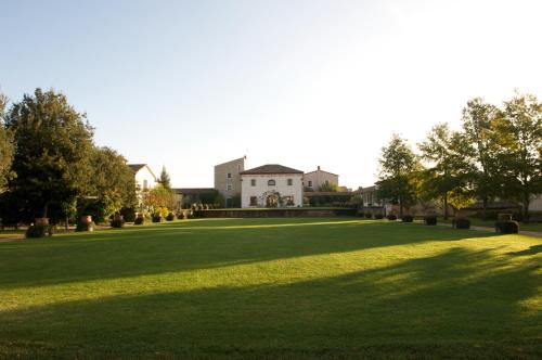 a large lawn with a house in the background at La Tenuta Dei Ciclamini in Avigliano