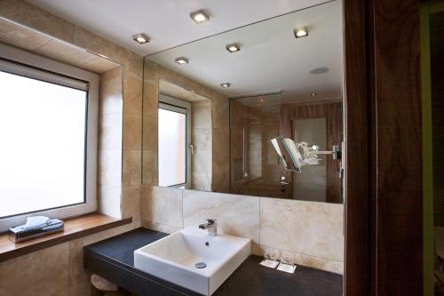 a bathroom with a sink and a mirror at Rochestown Park Hotel & Leisure Centre in Cork