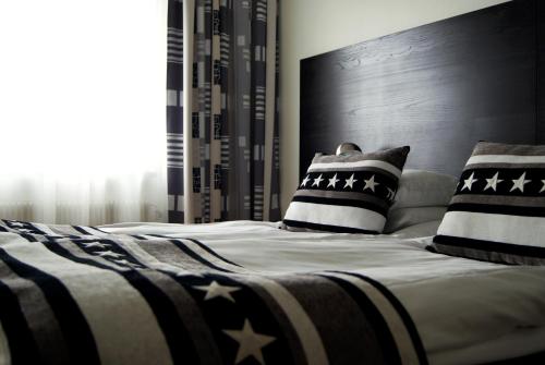 a bed with two pillows on it in a bedroom at Sure Hotel by Best Western City Jonkoping in Jönköping