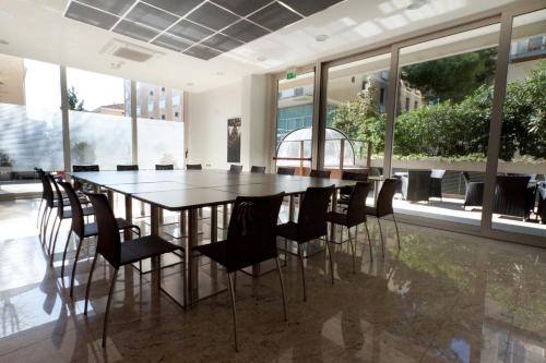 a dining room with a table and chairs at Hotel Cristallo in Rimini