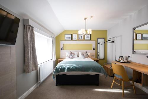 a bedroom with a bed and a desk at The Calverley Arms by Innkeeper's Collection in Pudsey