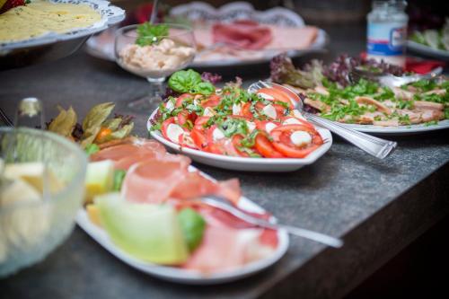 a bunch of plates of food on a table at Wein & Wohngut Paulushof in Pünderich