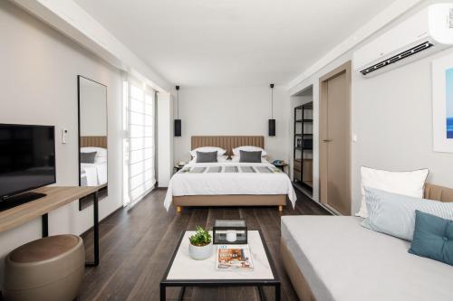 a bedroom with a bed and a couch at Gava Waterman Milna Resort – All Inclusive in Milna